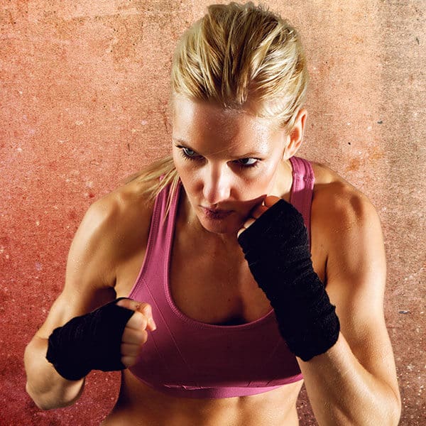Mixed Martial Arts Lessons for Adults in Arlington VA - Lady Kickboxing Focused Background