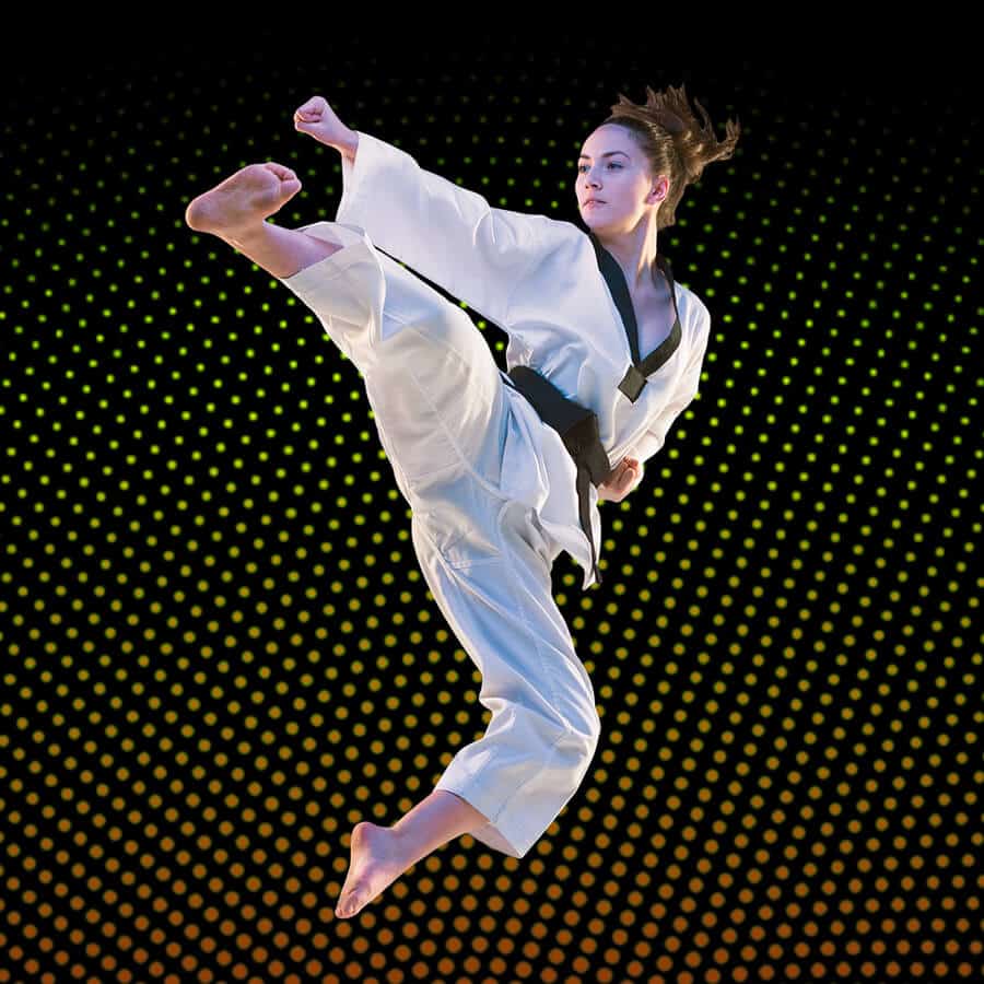 Martial Arts Lessons for Adults in Arlington VA - Girl Black Belt Jumping High Kick